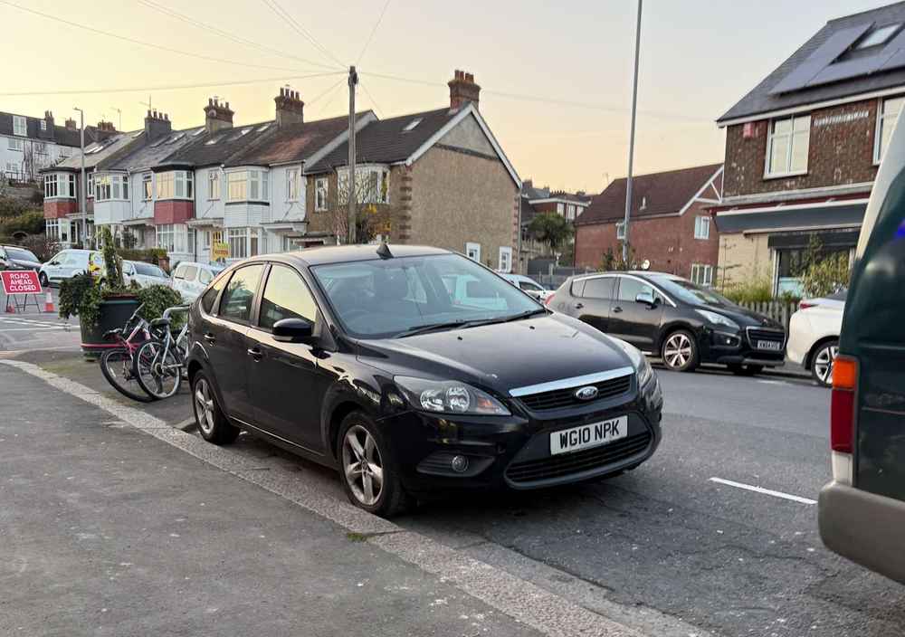 Photograph of WG10 NPK - a Black Ford Focus parked in Hollingdean by a non-resident. The nineteenth of nineteen photographs supplied by the residents of Hollingdean.