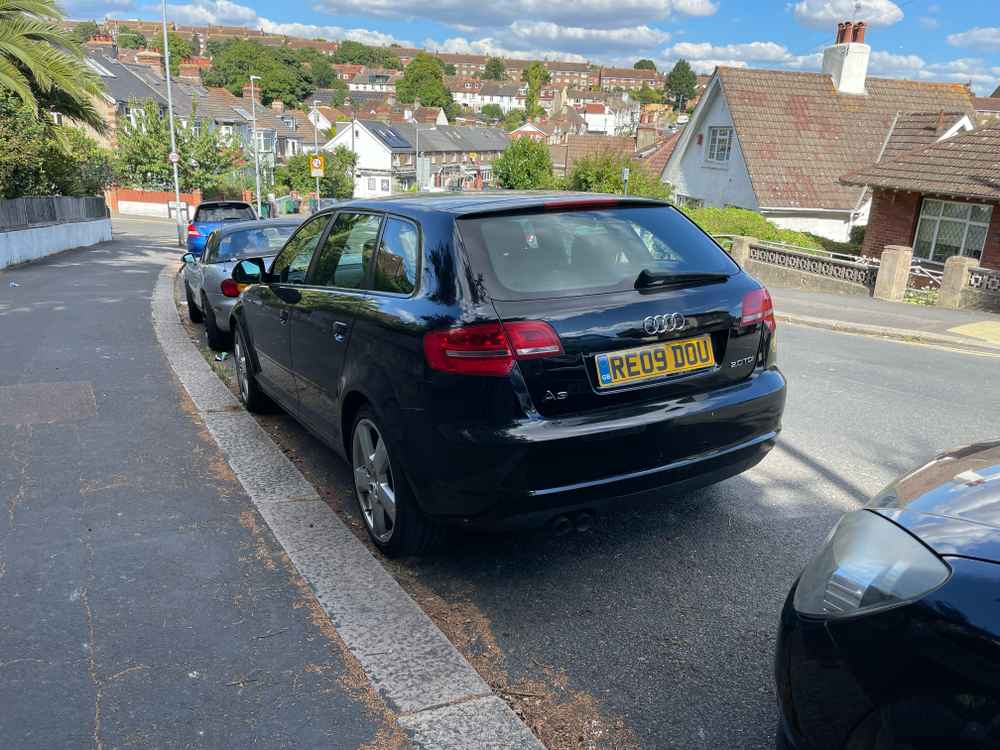 Photograph of RE09 DOU - a Black Audi A3 parked in Hollingdean by a non-resident who uses the local area as part of their Brighton commute. The first of eight photographs supplied by the residents of Hollingdean.