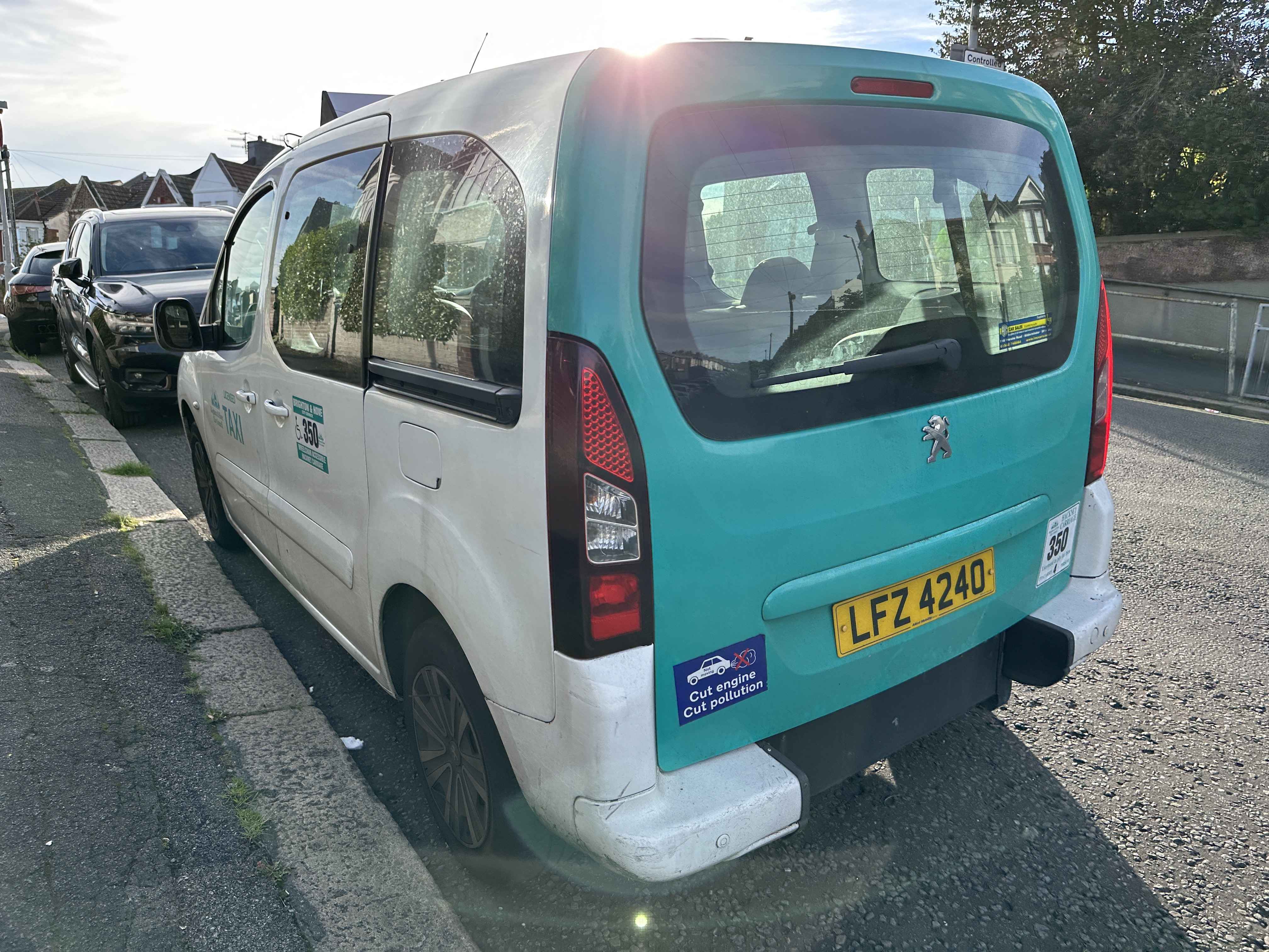 Photograph of LFZ 4240 - a White Peugeot Partner taxi parked in Hollingdean by a non-resident. The second of three photographs supplied by the residents of Hollingdean.