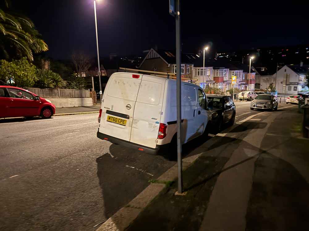 Photograph of MT60 CPE - a White Nissan NV200 parked in Hollingdean by a non-resident, and potentially abandoned. The thirteenth of thirteen photographs supplied by the residents of Hollingdean.