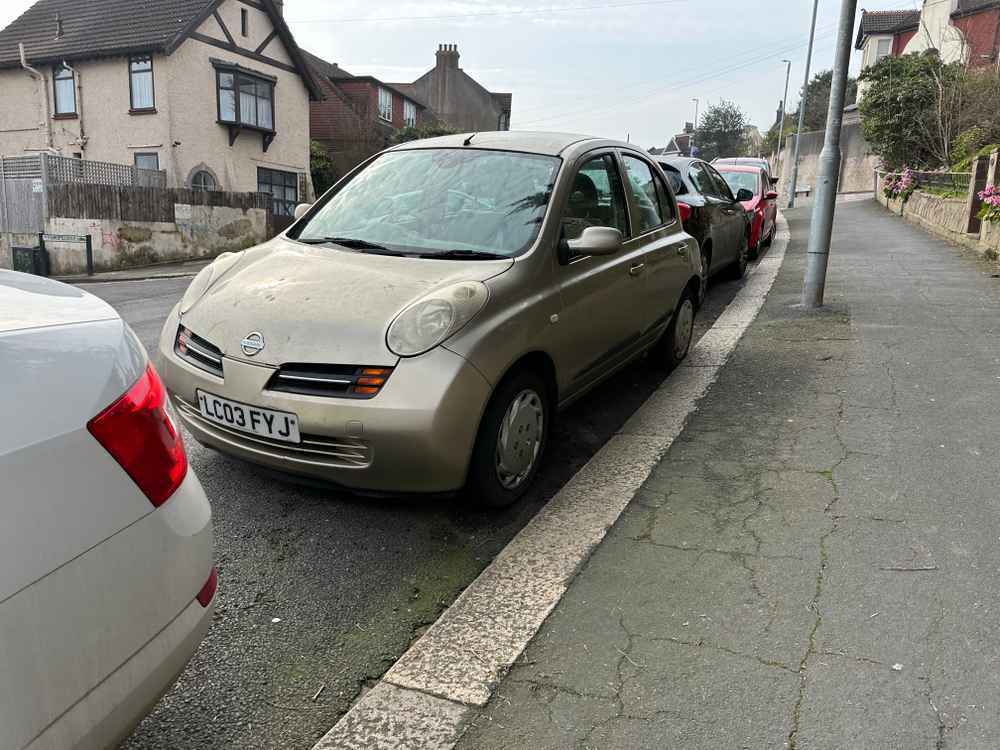 Photograph of LC03 FYJ - a Gold Nissan Micra parked in Hollingdean by a non-resident, and potentially abandoned. The fourteenth of twenty-three photographs supplied by the residents of Hollingdean.