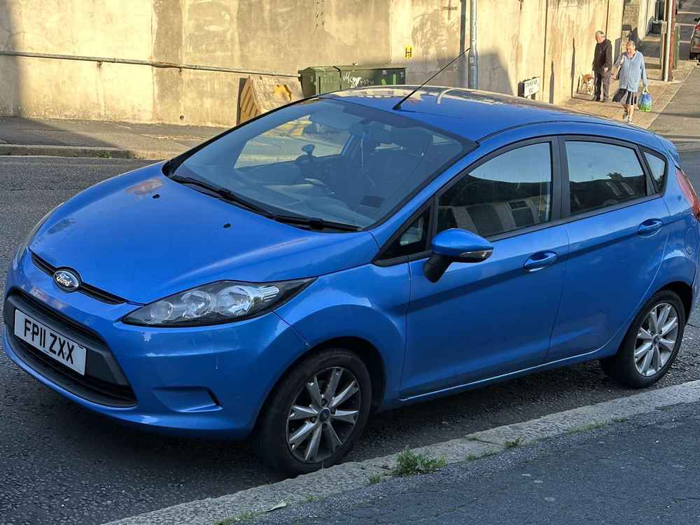 Photograph of FP11 ZXX - a Blue Ford Fiesta parked in Hollingdean by a non-resident who uses the local area as part of their Brighton commute.
