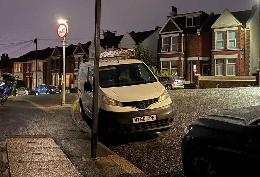 Photograph of MT60 CPE - a White Nissan NV200 parked in Hollingdean by a non-resident, and potentially abandoned. The eleventh of eleven photographs supplied by the residents of Hollingdean.