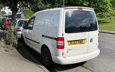 RJ12 RWF, a White Volkswagen Caddy parked in Hollingdean