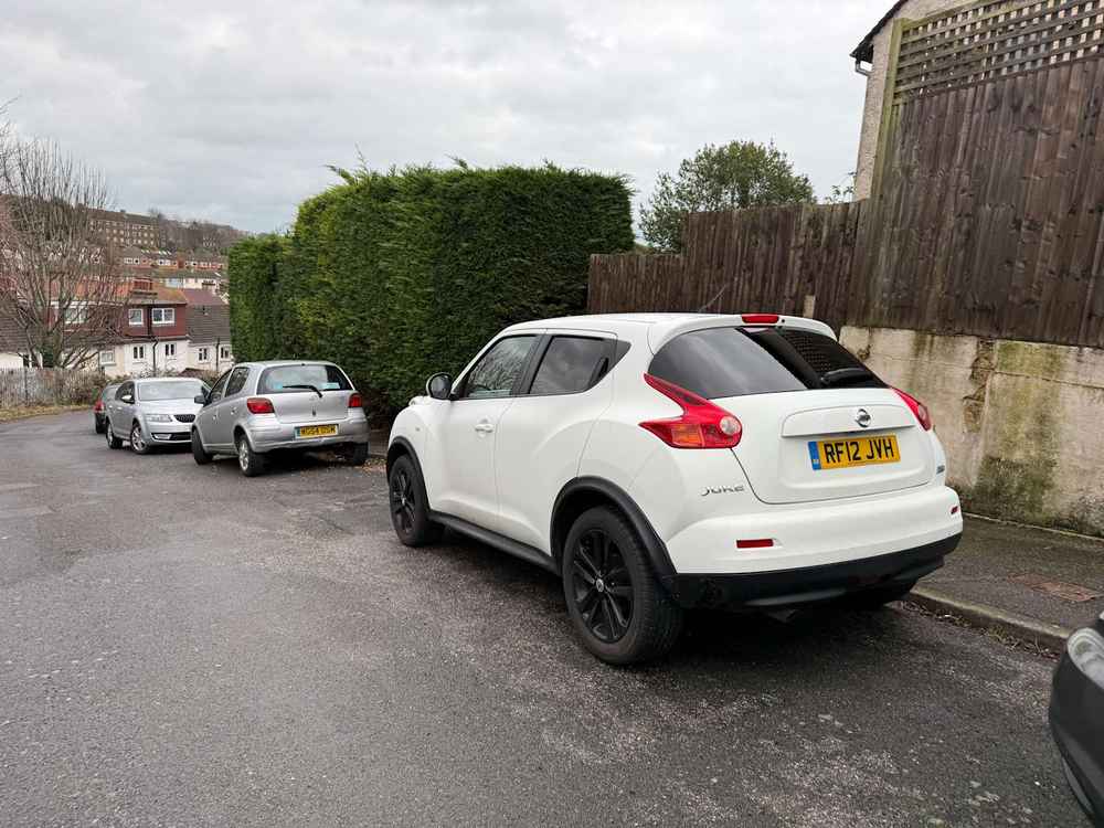 Photograph of RF12 JVH - a White Nissan Juke parked in Hollingdean by a non-resident who uses the local area as part of their Brighton commute. The twenty-third of twenty-five photographs supplied by the residents of Hollingdean.