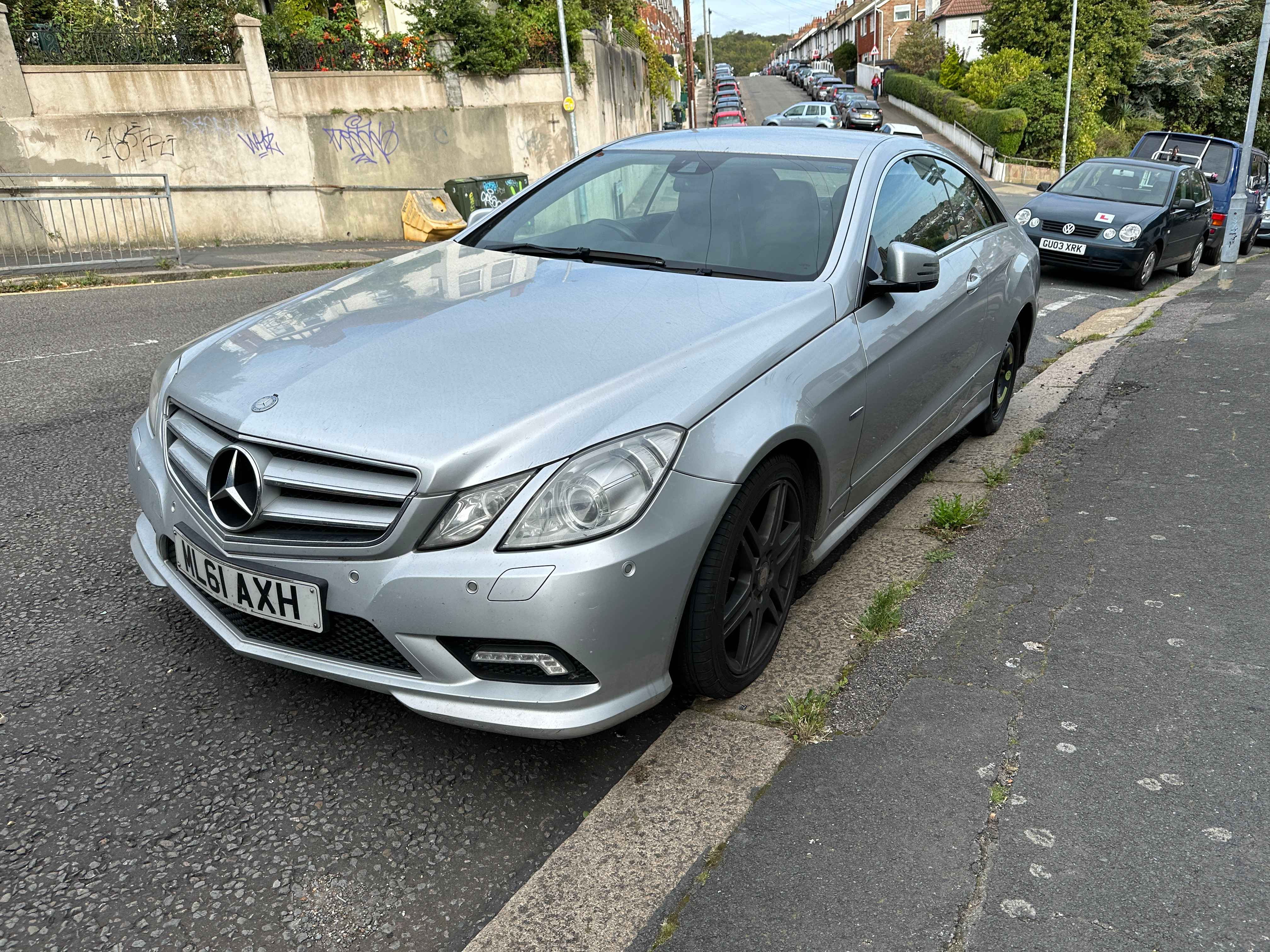 Photograph of ML61 AXH - a SIlver Mercedes E Class parked in Hollingdean by a non-resident, and potentially abandoned. The first of five photographs supplied by the residents of Hollingdean.