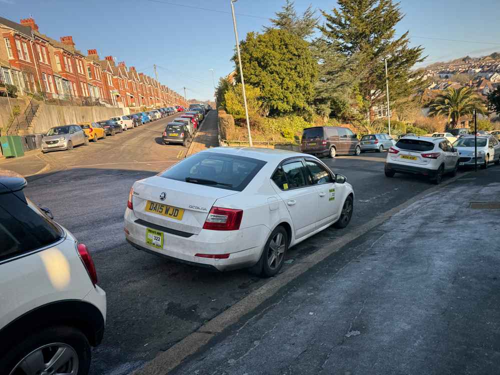 Photograph of DA15 WJD - a White Skoda Octavia taxi parked in Hollingdean by a non-resident. The fifteenth of fifteen photographs supplied by the residents of Hollingdean.