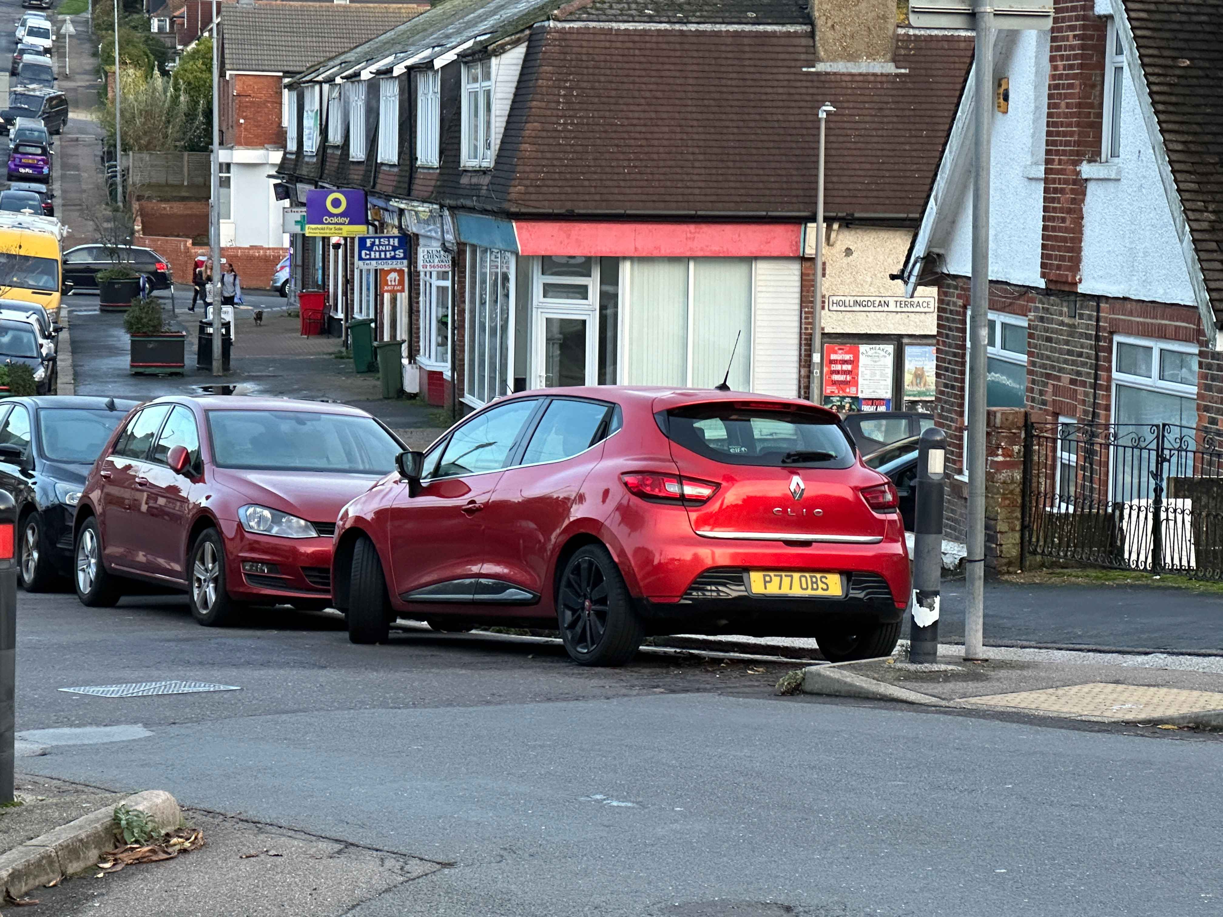 Photograph of P77 OBS - a Red Renault Clio parked in Hollingdean by a non-resident. The first of four photographs supplied by the residents of Hollingdean.