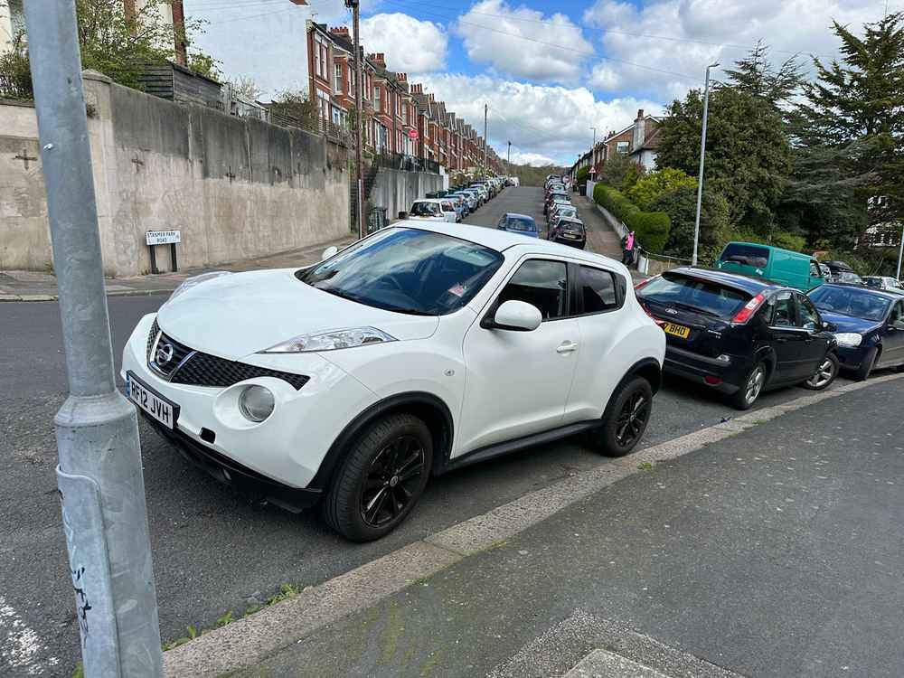 Photograph of RF12 JVH - a White Nissan Juke parked in Hollingdean by a non-resident who uses the local area as part of their Brighton commute. The sixth of twenty-five photographs supplied by the residents of Hollingdean.