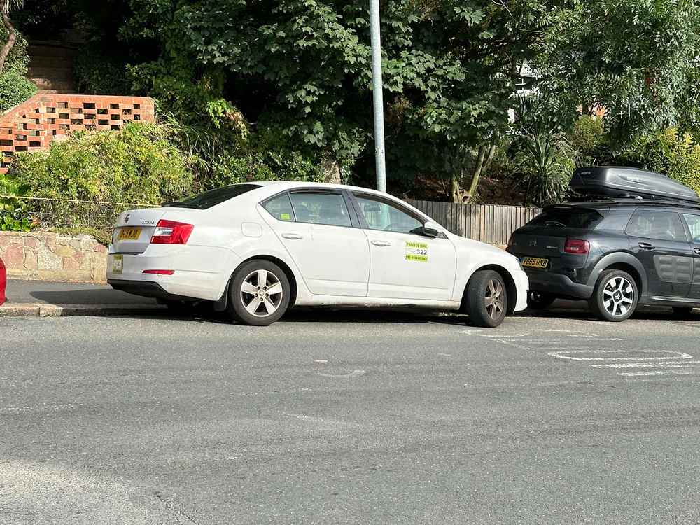 Photograph of DA15 WJD - a White Skoda Octavia taxi parked in Hollingdean by a non-resident. The twelfth of nineteen photographs supplied by the residents of Hollingdean.